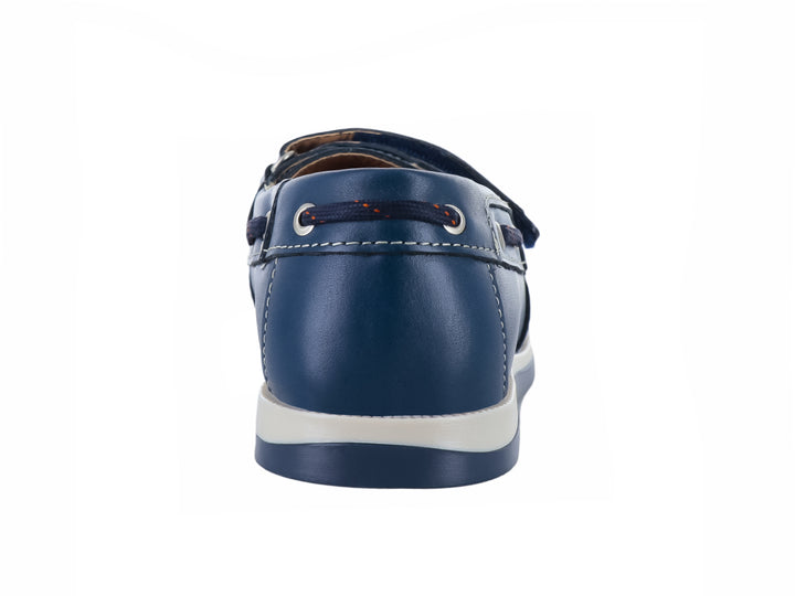 Zapato náutico infantil color azul marino con correa de velcro y suela blanca.