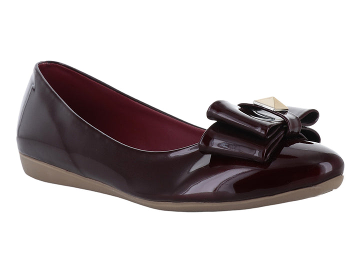 Zapato plano color vino en acabado charol brillante con detalle de moño decorativo en la parte frontal.