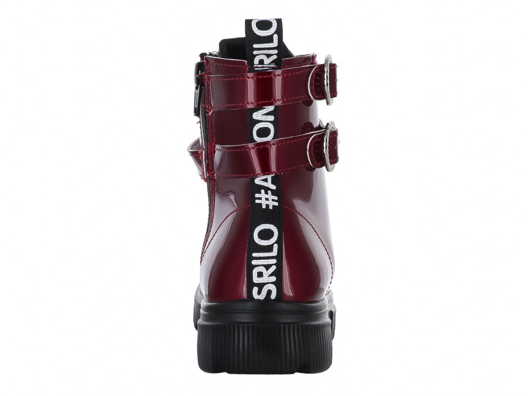 Bota de charol rojo con suela track negra, agujetas y hebillas laterales.