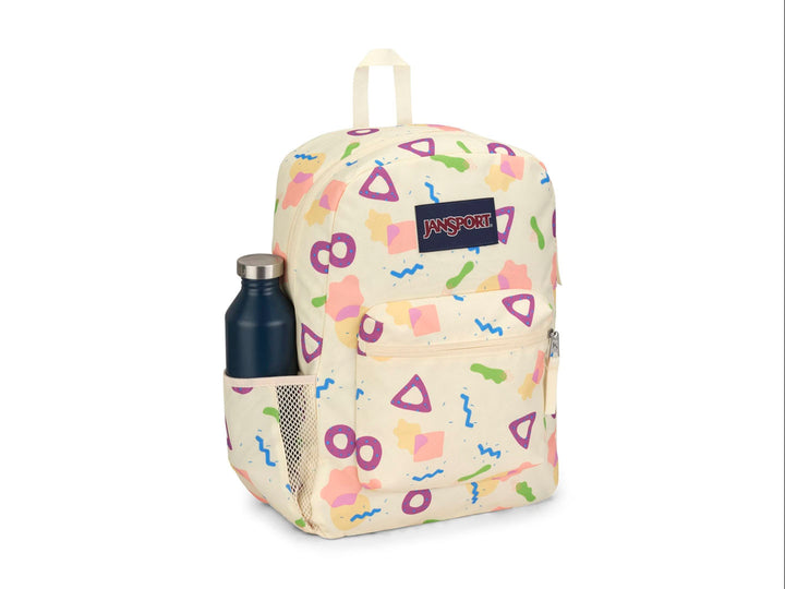 Mochila JanSport color beige con estampado de figuras geométricas en colores neón y logotipo frontal.