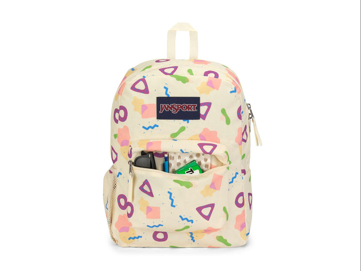 Mochila JanSport color beige con estampado de figuras geométricas en colores neón y logotipo frontal.