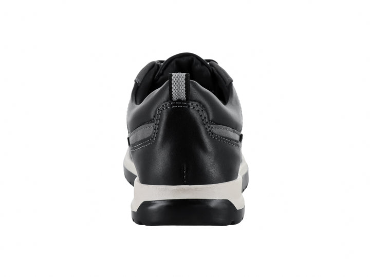 Tenis infantiles color negro con suela blanca y cordones, estilo casual.
