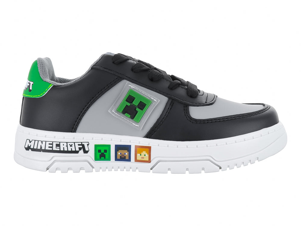 Tenis infantiles color negro y gris con detalles temáticos de Minecraft y suela blanca.