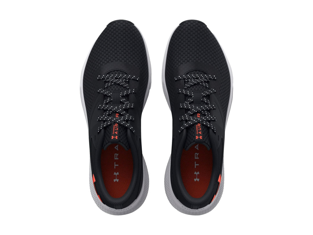 Tenis deportivos Under Armour color negro con suela blanca y logotipo rojo en el costado.