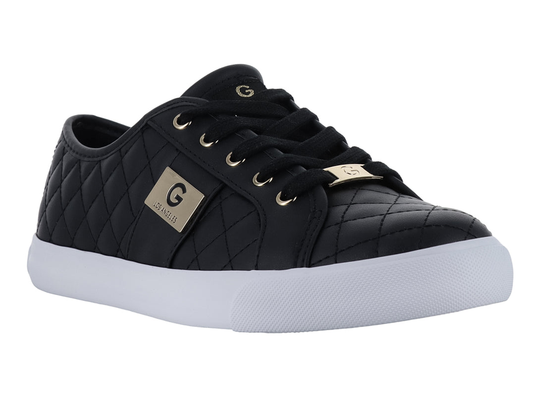 Tenis casuales negros para mujer con suela blanca y detalles dorados.