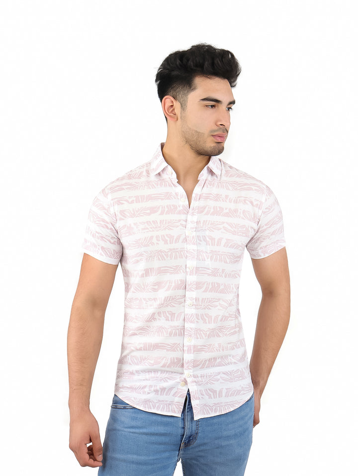 Hombre vistiendo una camisa de manga corta color beige con estampado de hojas.