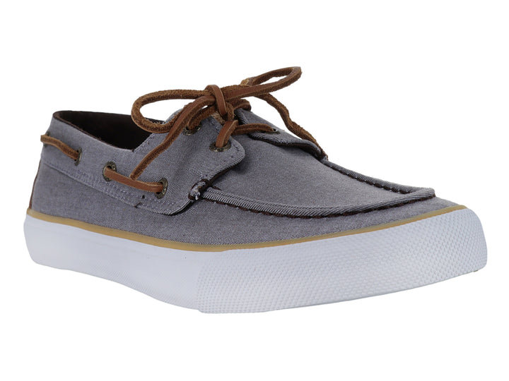 Zapato náutico Sperry de tela gris con cordones cafés y suela blanca.