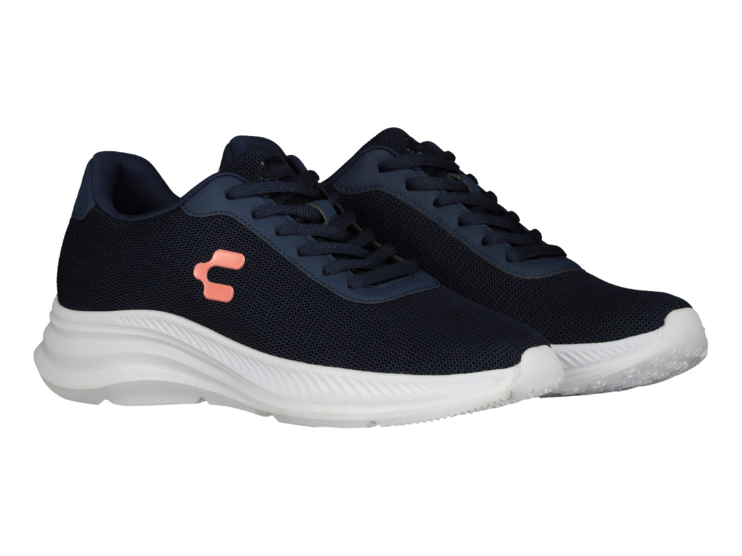 Tenis deportivos Charly en color azul marino con suela blanca y logo naranja lateral.