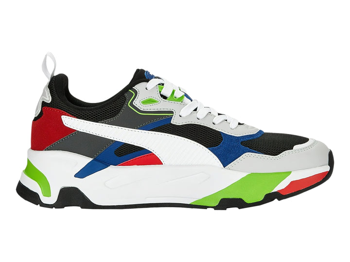 Tenis PUMA multicolor con suela blanca gruesa y detalles en rojo, azul y verde.