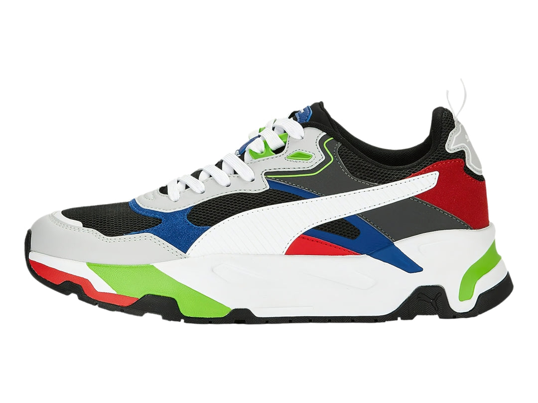 Tenis PUMA multicolor con suela blanca gruesa y detalles en rojo, azul y verde.