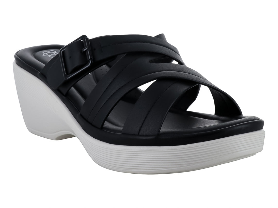 Sandalia de plataforma color negro con suela blanca y correas cruzadas con hebilla.