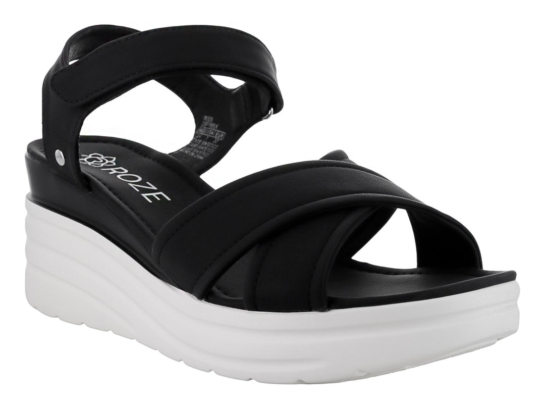 Sandalias de plataforma color negro con suela blanca y correas cruzadas.