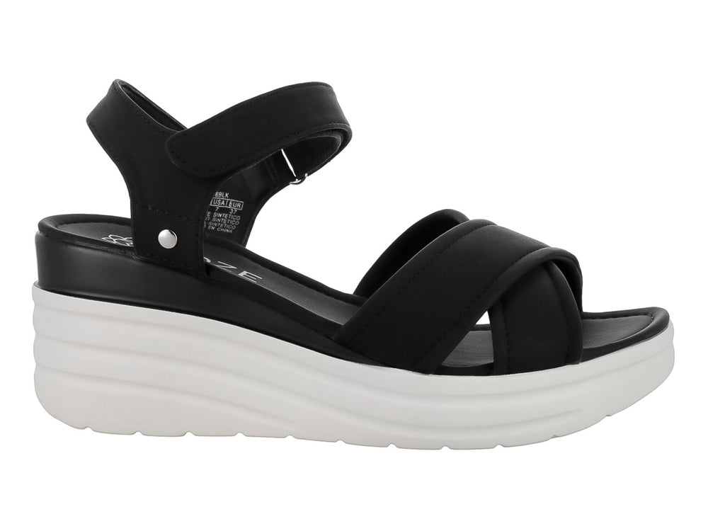 Sandalias de plataforma color negro con suela blanca y correas cruzadas.