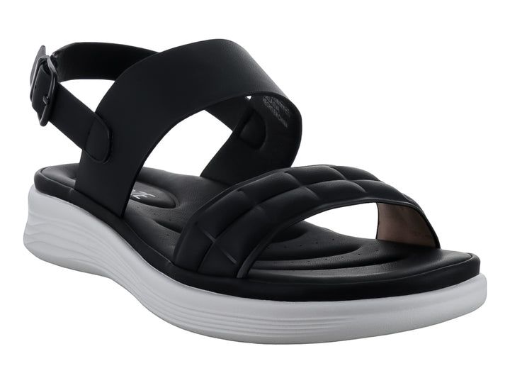 Sandalias negras de plataforma con correas acolchadas y suela blanca para niña.