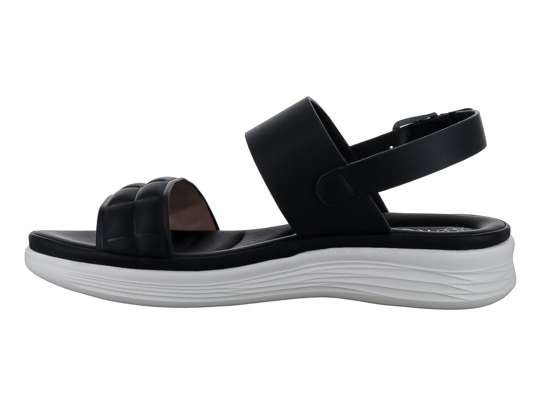 Sandalias negras de plataforma con correas acolchadas y suela blanca para niña.