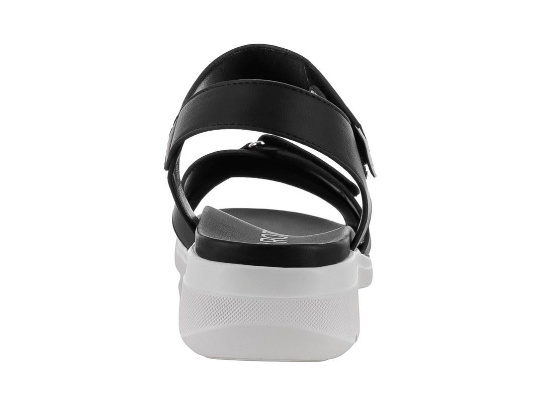 Sandalia ROZE color negro con suela blanca, correas ajustables de velcro y diseño casual.