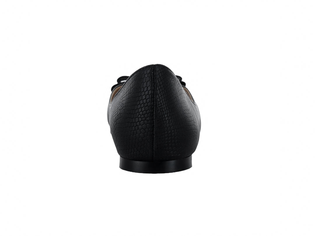 Zapato plano negro para mujer con textura de piel de anaconda y adorno de moño con detalle dorado.