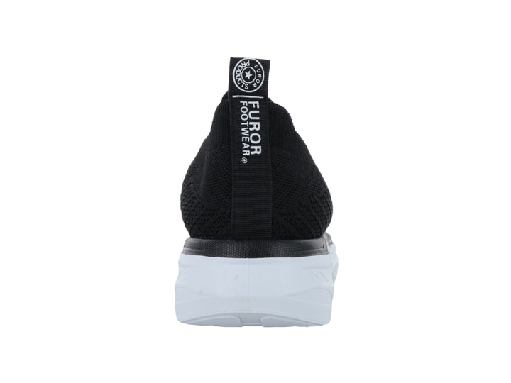 Tenis Furor negros de tela sin cordones con suela blanca gruesa y contours modernos.