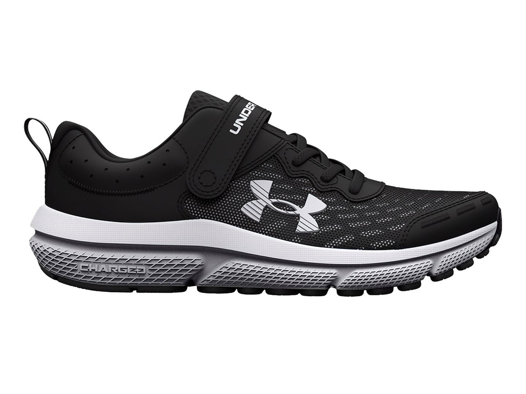Tenis deportivos Under Armour color negro con suela blanca, cierre de correa y agujetas.