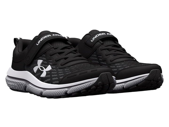 Tenis deportivos Under Armour color negro con suela blanca, cierre de correa y agujetas.