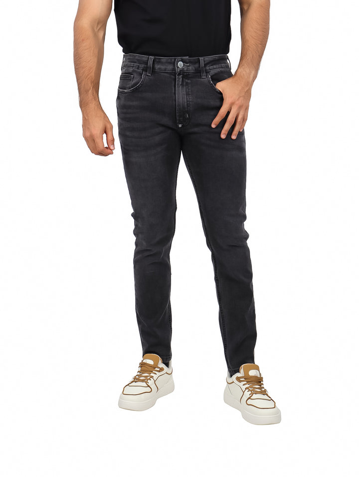 Hombre vistiendo pantalones jeans ajustados de color negro.
