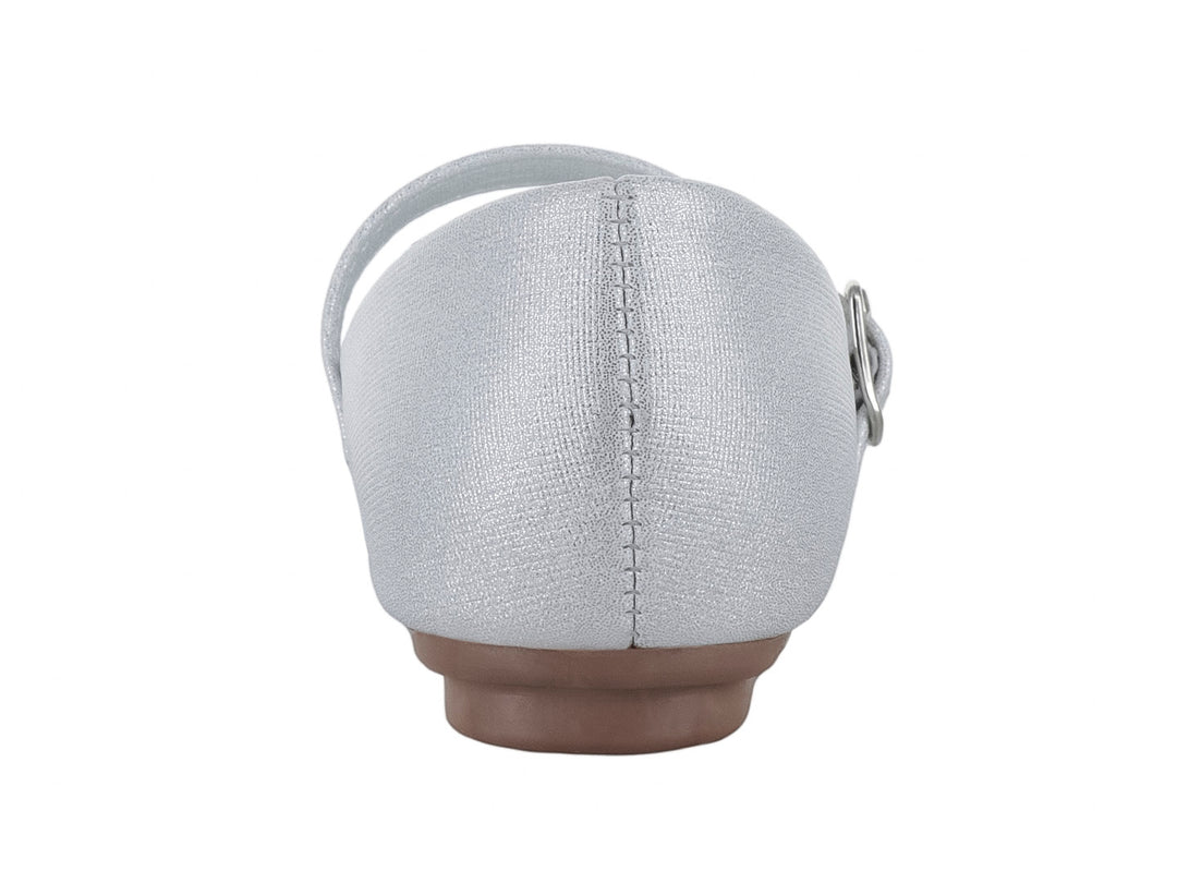 Zapato plano blanco brillante para niña con moño decorado y correa ajustable.