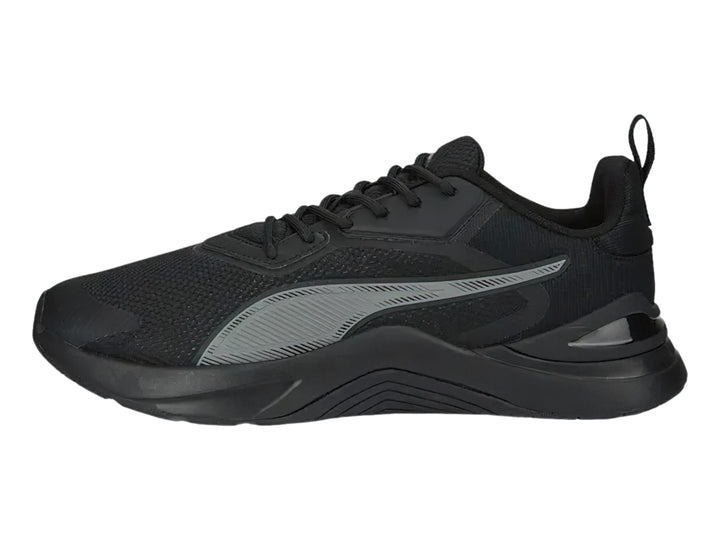 Tenis deportivos PUMA en color negro y gris oscuro con diseño moderno de malla y suela robusta.
