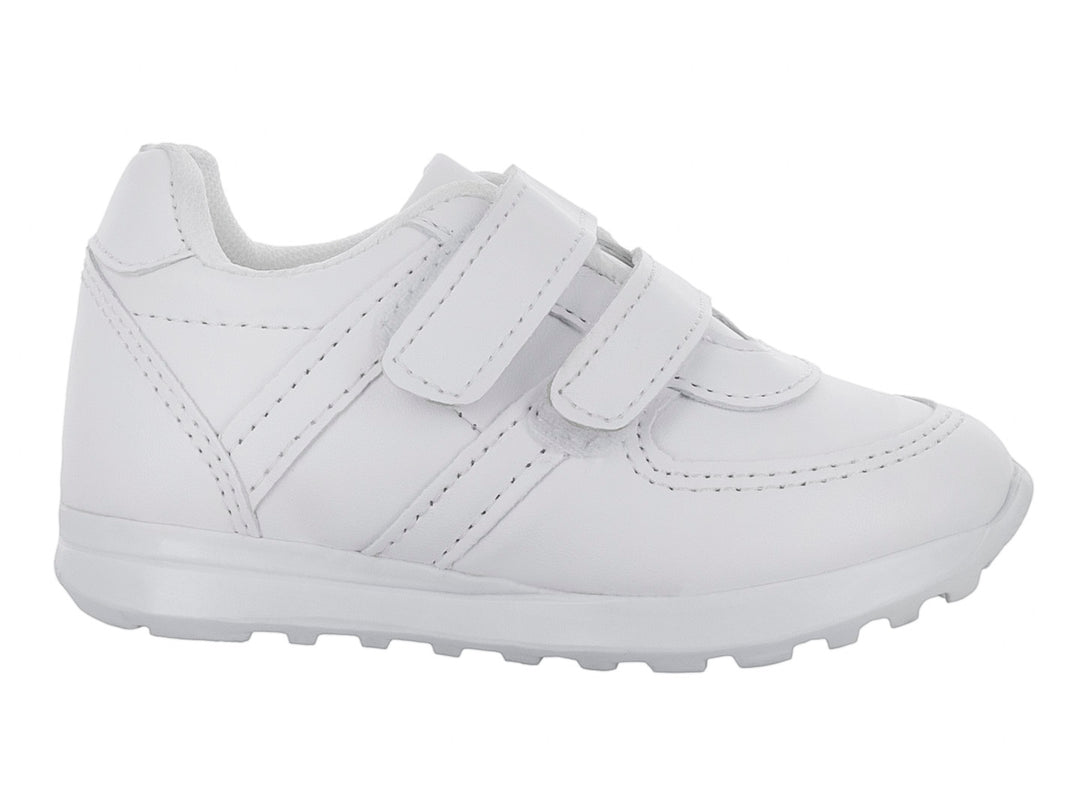 Zapato escolar blanco para niño con cierre de velcro y suela blanca.