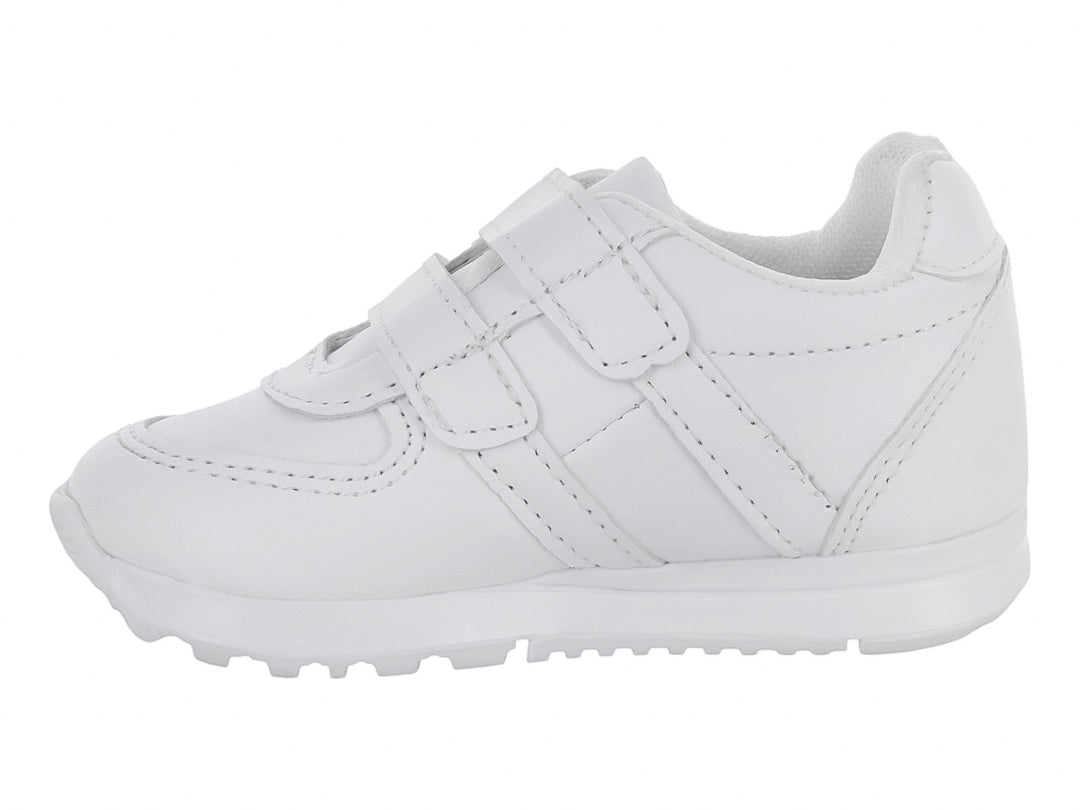 Zapato escolar blanco para niño con cierre de velcro y suela blanca.