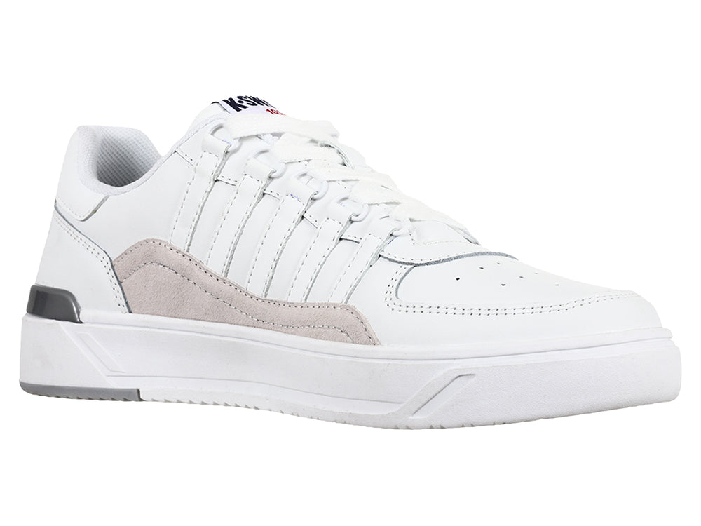 Tenis K-Swiss blancos con franja lateral gris y suela blanca, vista de perfil.