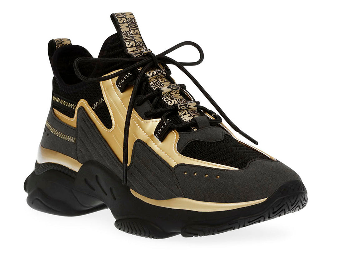Tenis Steve Madden Match Box en color negro con detalles dorados y suela chunky robusta.