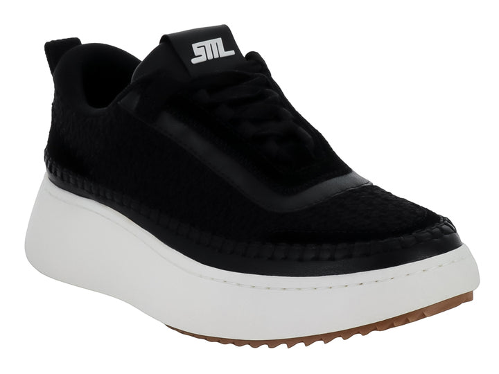 Tenis Steve Madden Double Take en color negro con suela blanca gruesa y base café.