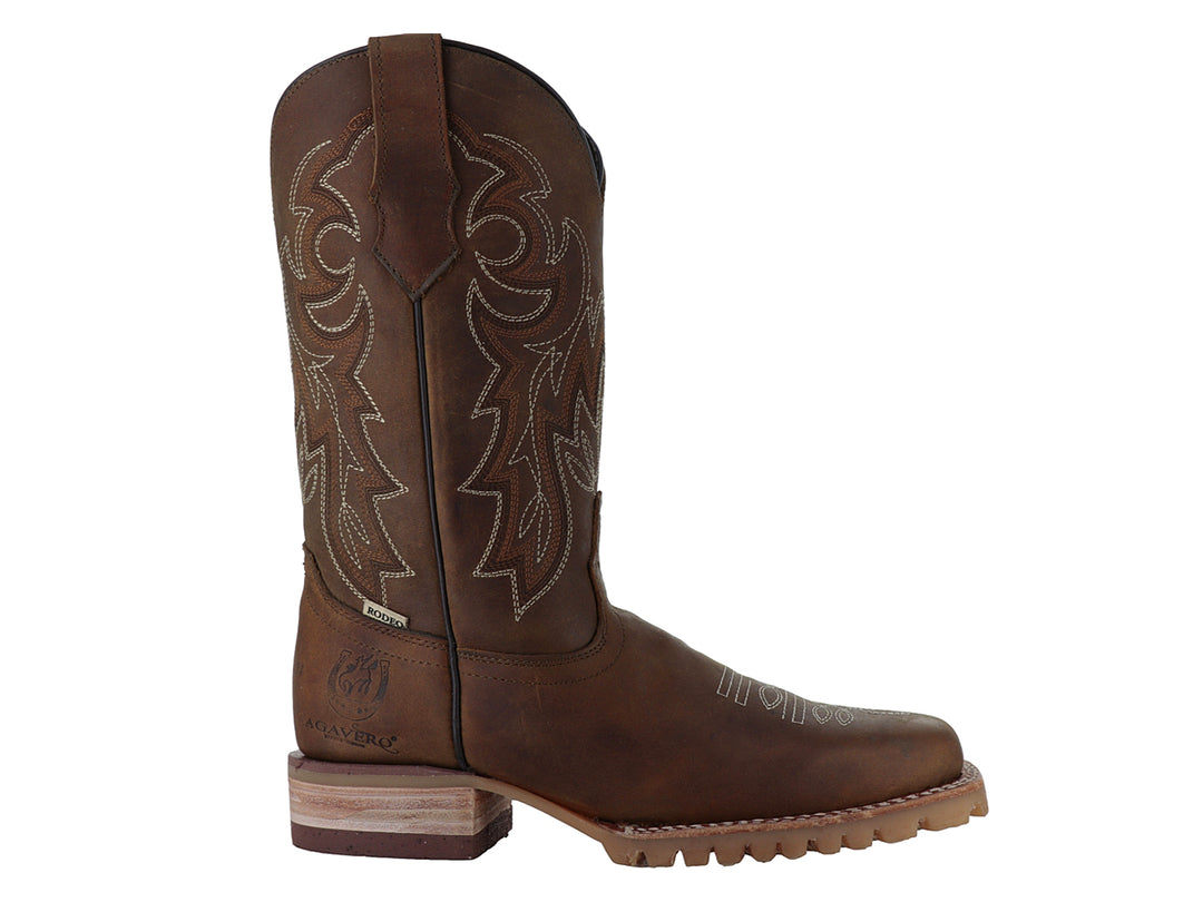 Bota vaquera de cuero color miel con bordados decorativos y suela robusta.