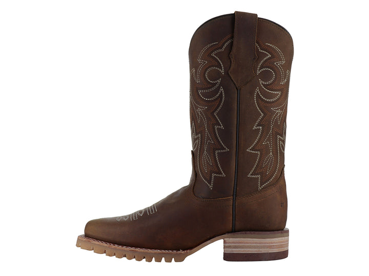 Bota vaquera de cuero color miel con bordados decorativos y suela robusta.