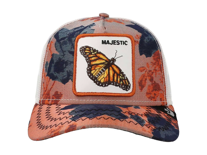 Gorra Goorin Bros con estampado floral en tonos naranja y azul, featuring un parche central de una mariposa monarca.