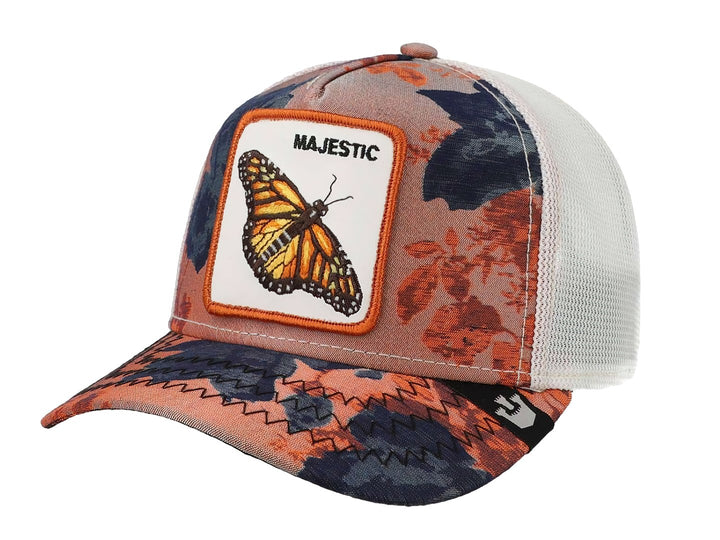 Gorra Goorin Bros con estampado floral en tonos naranja y azul, featuring un parche central de una mariposa monarca.