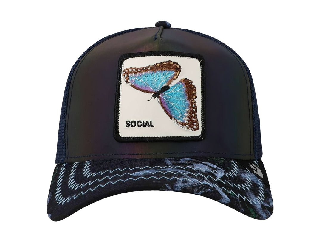 Gorra azul Goorin Bros con parche frontal de una mariposa azul y blanca sobre fondo blanco.