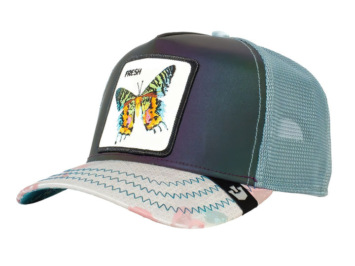 Gorra snapback Goorin Bros con parche de mariposa, panel frontal oscuro y visera con estampado floral.