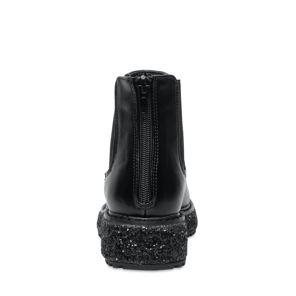 Botas negras Steve Madden con suela gruesa moteada en blanco y negro, acabado brillante y cierre lateral.