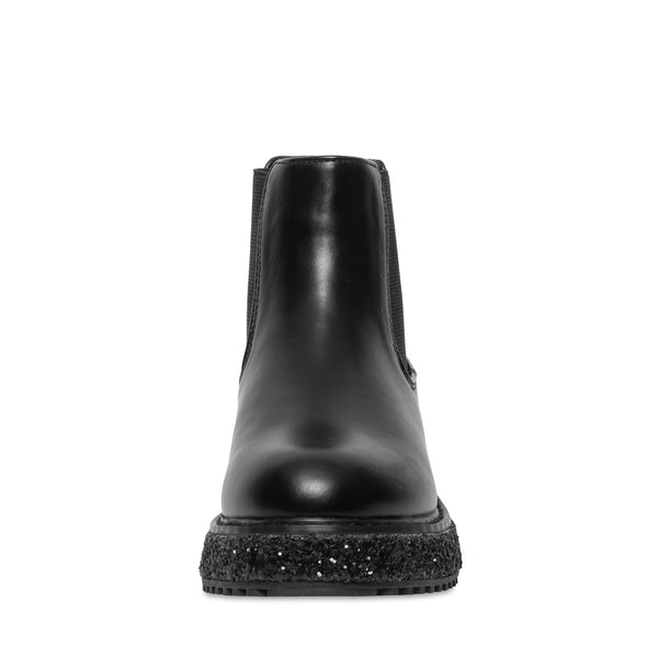 Botas negras Steve Madden con suela gruesa moteada en blanco y negro, acabado brillante y cierre lateral.