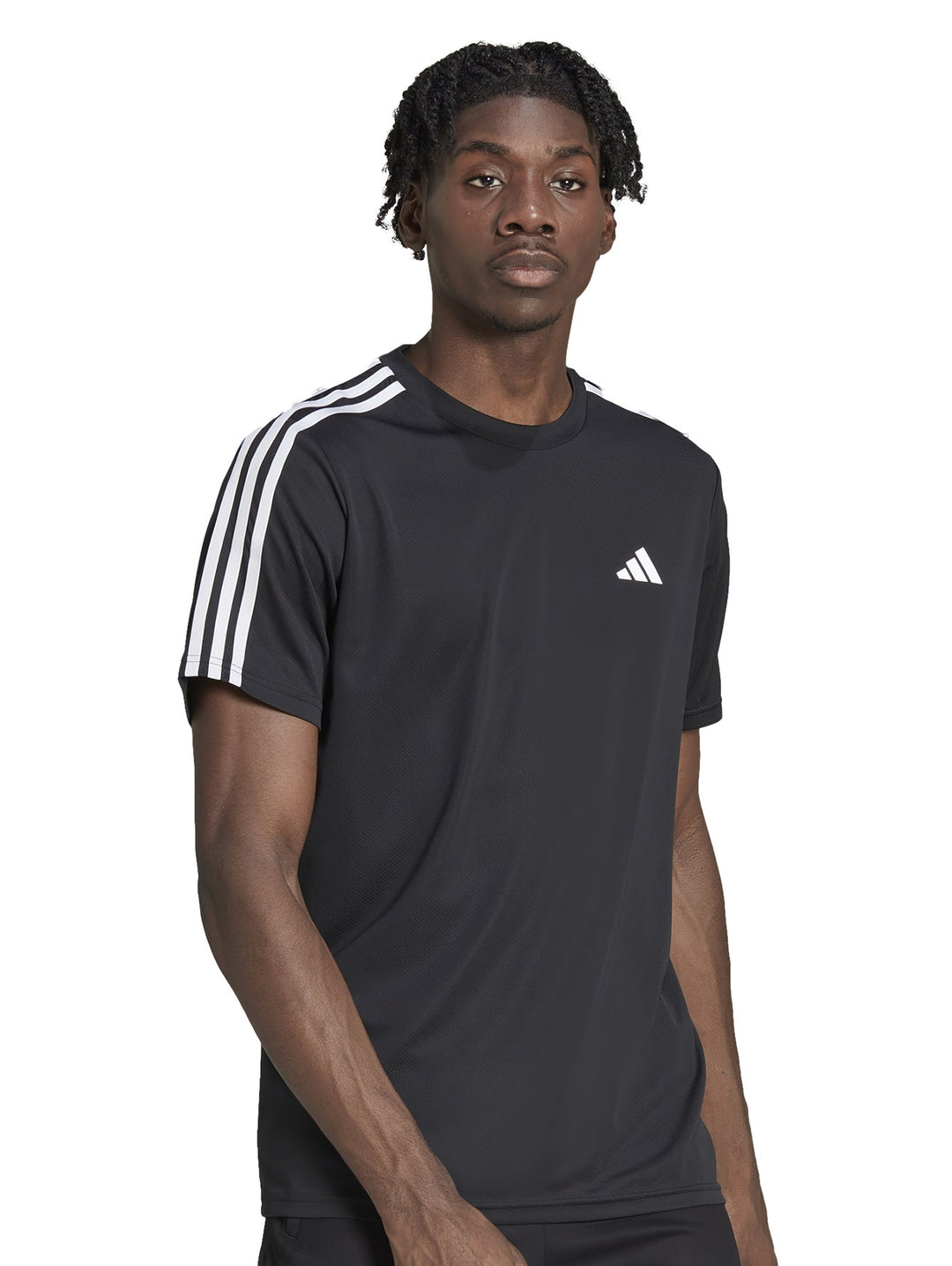 Hombre vistiendo playera deportiva Adidas color negro con tres franjas blancas en los hombros y logo blanco al pecho.