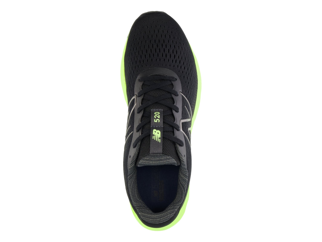 Tenis New Balance deportivos en color negro con suela gruesa verde neón y detalles en rojo.