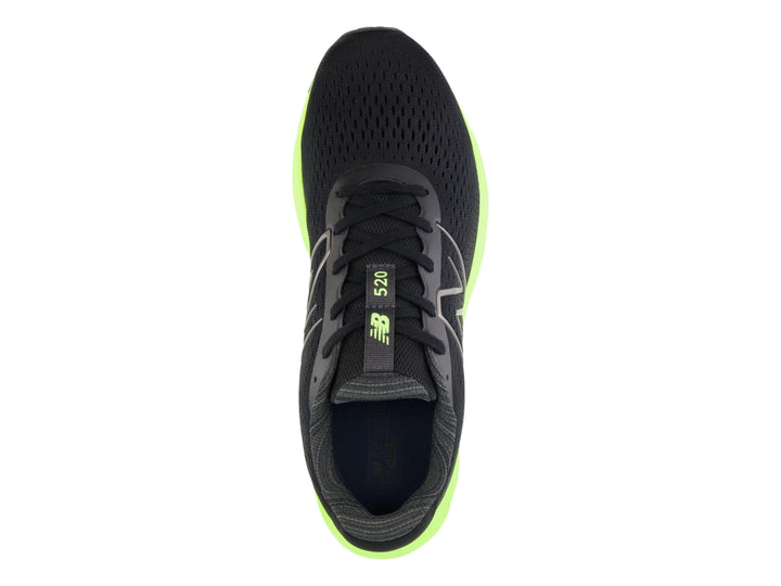 Tenis New Balance deportivos en color negro con suela gruesa verde neón y detalles en rojo.