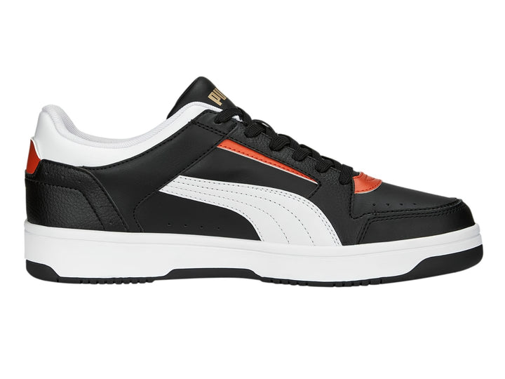 Tenis PUMA Rebound Joy Low en color negro con detalles en blanco y naranja, suela blanca y corte bajo.