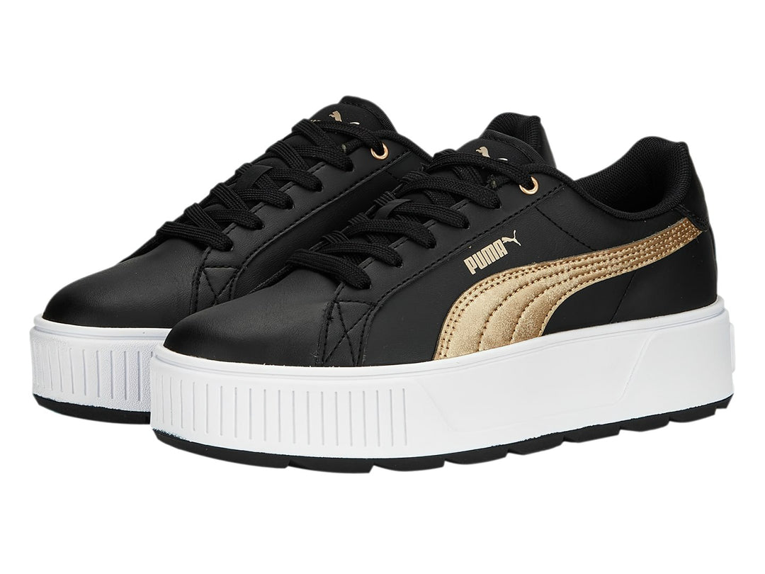 Tenis PUMA modelo Carmen Space Metallics en color negro con franja dorada y suela de plataforma blanca.