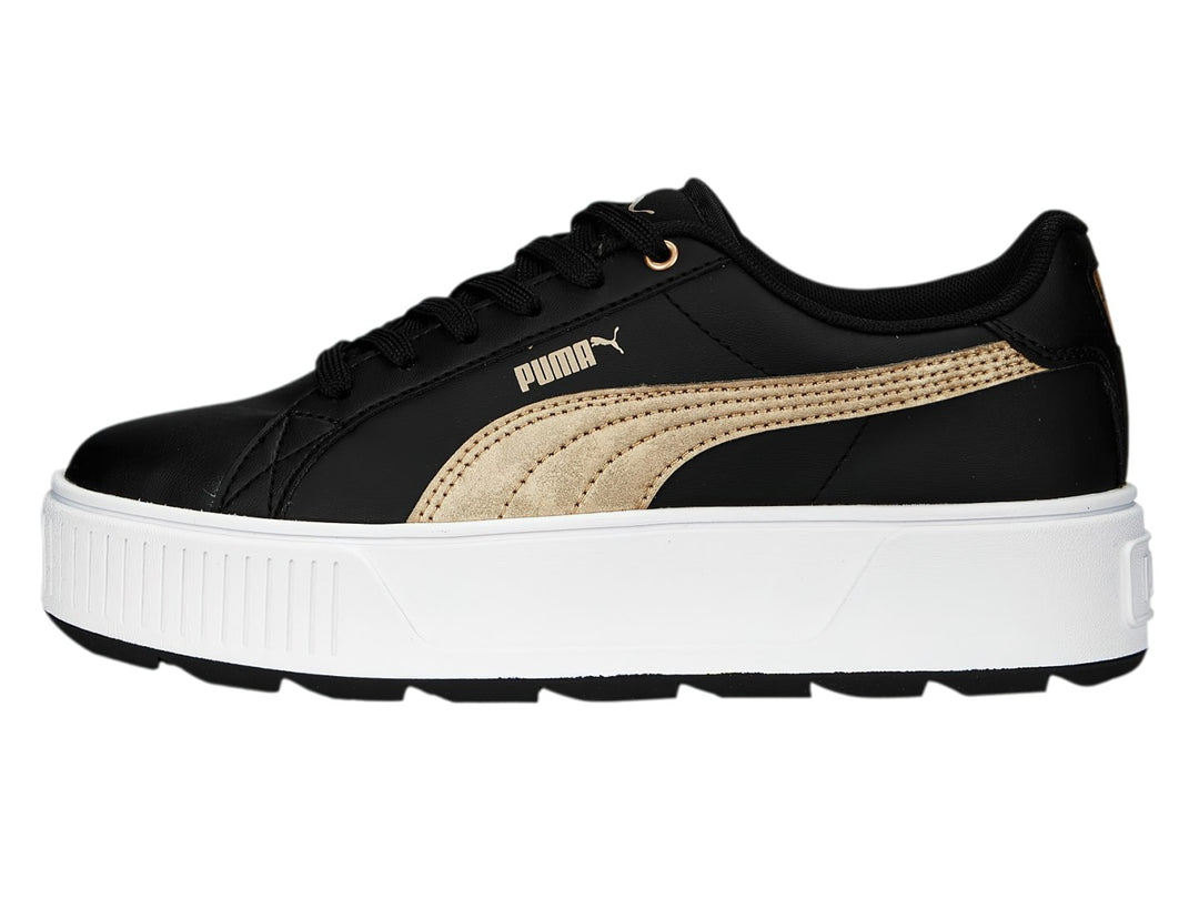Tenis PUMA modelo Carmen Space Metallics en color negro con franja dorada y suela de plataforma blanca.