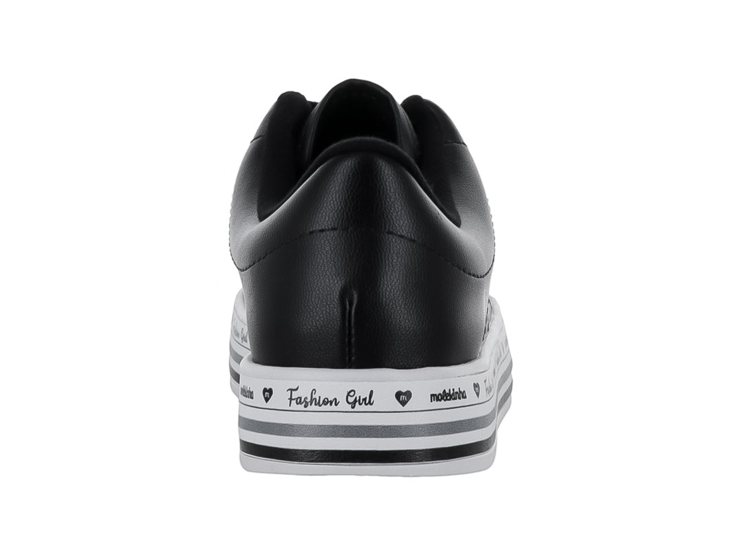 Tenis negros de la marca Molekinha con suela blanca decorada y ojillos de colores para Niña.