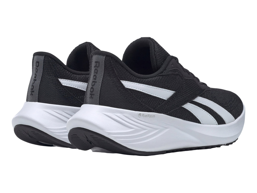 Tenis deportivos Reebok color negro con suela blanca y detalles laterales blancos.