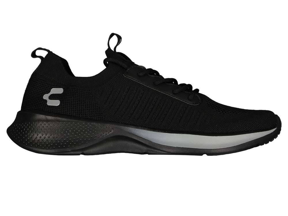 Par de tenis deportivos color negro con suela ligera y detalles en gris.