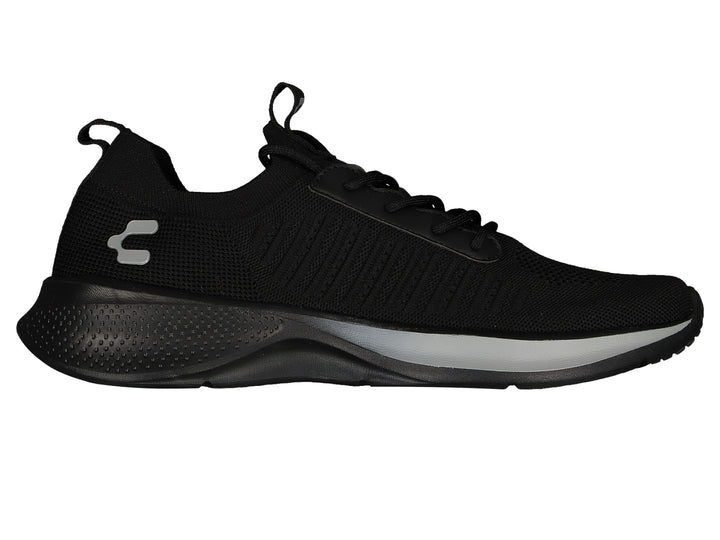 Par de tenis deportivos color negro con suela ligera y detalles en gris.